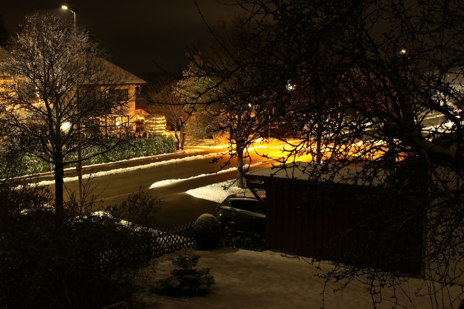 Snowy suburban street at night
